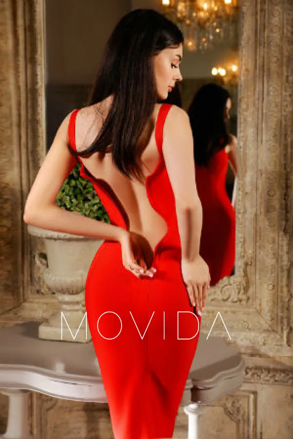 back view of Coleta wearing a red dress Profile Image